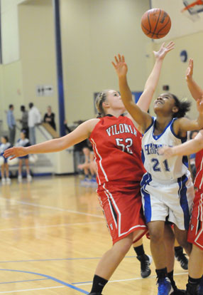 Bryant's Destiny Martin (21) tries to split a pair of Vilonia defenders including Abby Hightower (52). (Photo by Kevin Nagle)