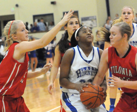 Bryant's Dejai Rayford is surrounded by Vilonia players as she tries to drive to the basket. (PHoto by Kevin Nagle)