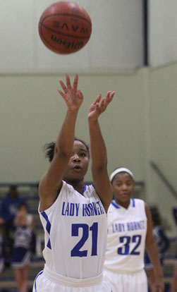 Destiny Martin (21) launches a free throw as teammate Deja Rayford (32) looks on. (Photo by Rick Nation)