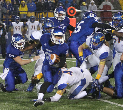 Brushawn Hunter tries to turn the corner off of blocks by Kurt Calley (61) and Jacob Ward (65). (Photo by Rick Nation)