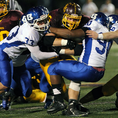 Hunter Fugitt (33), Mario Waits (90) and Austin May tackle Lake Hamilton's big fullback Chris Eastburn. (Photo by Rick Nation)