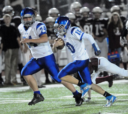 Mike Jones heads upfield with an escort from Kobi Riffe (74). (Photo by Kevin Nagle)