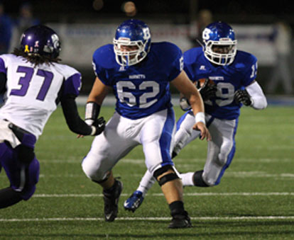 Kylon Boyle (19) cuts off a block by Josh Earls (62). (Photo by Rick Nation)