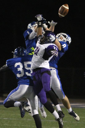 Bryant's Jake Johnson (35), Drew Tipton (1) and Davis Nossaman (8) break up a pass intended for El Dorado's Dadraques Harris. (Photo by Rick Nation)