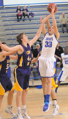 Bryant's Landon Kays (33) fires up a shot over Catholic's Duncan Diaz. (Photo by Kevin Nagle)