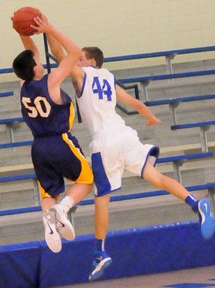 Bryant's Trey Ashmore (44) blocks a shot by Catholic's Josh Neuman. (Photo by Kevin Nagle)