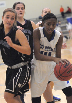 Lania Ratliff (10) grabs a loose ball in the midst of Mount St. Mary players. (Photo by Kevin Nagle)