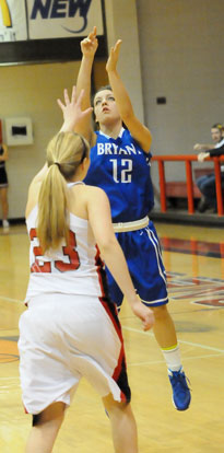 Maddie Baxter (12) launches a 3 in front of Russellville's Kenzie Wiedower. (PHoto by Kevin Nagle)