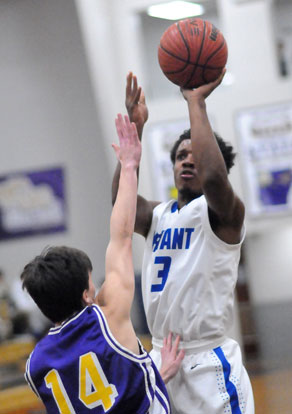 C.J. Rainey (3) fires up a shot over Catholic's Chad Wharton (14). (Photo by Kevin Nagle)