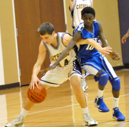 Kevin Hunt (10) tries for a steal against Catholic's Drake Enderlin. (Photo by Kevin Nagle)