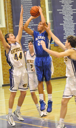 Jaelynn Jones (25) shoots over Little Rock Catholic's Drake Enderlin (44) and Chad Wharton (2). (Photo by Kevin Nagle)