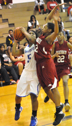 Dezerea Duckworth (5), guarded by Texarkana's Jasmine Allen. (Photo by Kevin Nagle)