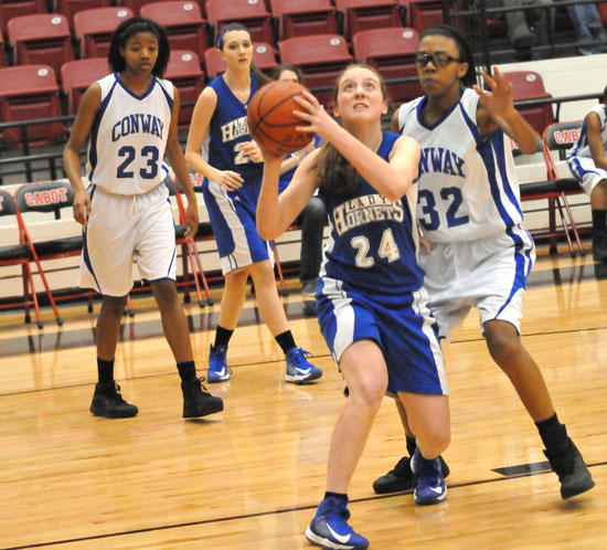 Bryant's Britney Sahlmann (24) sets to shoot in front of Conway White's Delia Brown. (Photo by Kevin Nagle)
