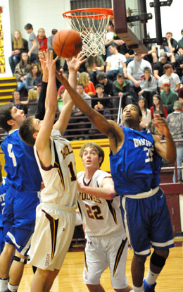 Brian Reed (35) and Luke Rayburn (4) battle for a rebound. (Photo by Kevin Nagle)