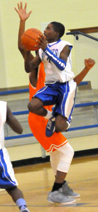 Calvin Allen double clutches as he goes to the basket past a taller Ridge Road defender. (Photo by Kevin Nagle)