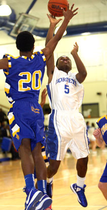 Kris Croom (5) shoots over Rokar Williams. (Photo by Rick Nation)