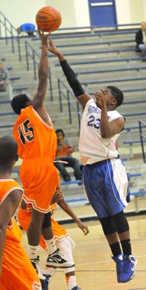 Phillip Isom-Green (23) stretches to get a shot away over a Ridge Road defender. (Photo by Kevin Nagle)