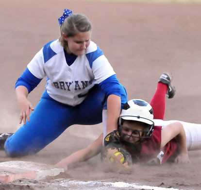 Kaley Coppock, left, applies a tag at first base. (Photo by Kevin Nagle)