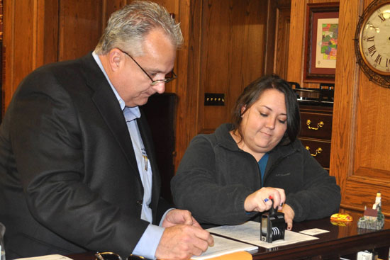 Lauren Copeland, an Ethics Compliance Officers in the Election Division of the Office of Secretary of State files Saline County Circuit Clerk Dennis Milligan’s paperwork to form an exploratory committee for a 2014 race for Arkansas Treasurer.