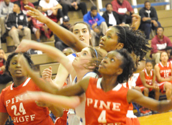 Courtney Davidson gets tangled up with a trio of Pine Bluff players in front of teammate Whitney Meyer. (Photo by Kevin Nagle)