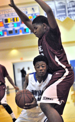 Bryant senior Strodney Davis tries to make some room against Pine Bluff's John Tate. (Photo by Kevin Nagle)