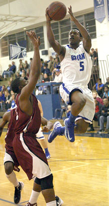 Bryant's K.J. Hill flies past a Pine Bluff defender on the way to the hoop. (Photo by Rick Nation)