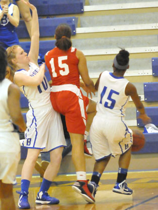 Bryant's Kristen Scarlett cuts off the drive of Pine Bluff's Jasmyn Eckermann as teammate Jayla Anderson (15) pokes the ball away. (Photo by Kevin Nagle)