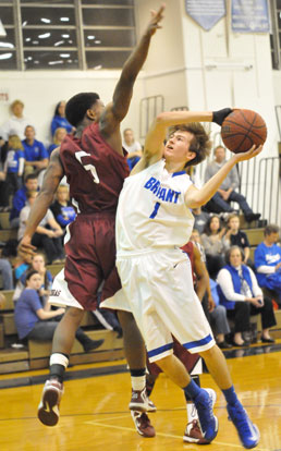 Tyler Simmons twists to try to get a shot past Pine Bluff's Derrick Rice. (Photo by Kevin Nagle)