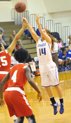 Peyton Weaver (14) gets hacked on the wrist as she releases a 3-pointer. No foul was called. (Photo by Kevin Nagle)