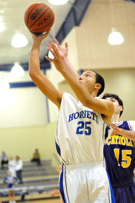 Bryant's Jaelynn Jones puts up a shot in front of Catholic's Andre Sale (15). (Photo by Kevin Nagle)