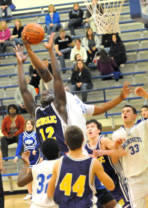 Bryant's Cameron Murray battles with Catholic's Lance Thomas (12) for a rebound. (Photo by Kevin Nagle)