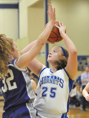 Anna Turpin (25) looks to shoot over Mount St. Mary's McKenzie Bridges. (Photo by Kevin Nagle)