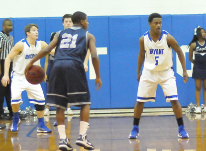 Bryant's Skyler McKissock, Zach Cambron and K.J. Hill set up defensively against J.A. Fair's Jerrick Cole. (Photo by Kevin Nagle)