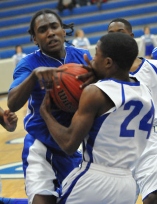 Bryant's Simeon Watson (4) is tied up by Conway Blue's Orlando Phillips. (Photo by Kevin Nagle)
