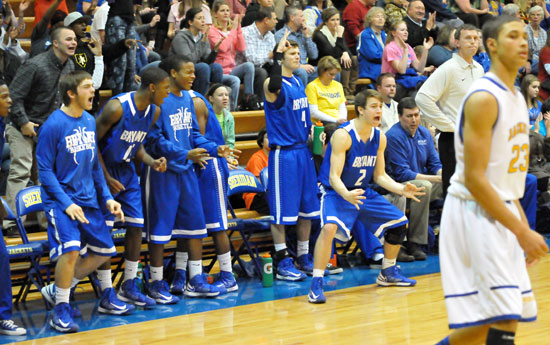 The Bryant bench celebrates a clutch 3-pointer by Tyler Simmons late in Friday's game at Sheridan. (Photo by Kevin Nagle)