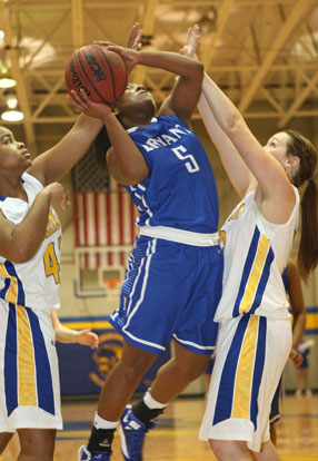 Dezerea Duckworth tries to get a shot away against a pair of Sheridan defenders. (Photo by Rick Nation)