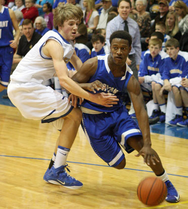 K.J. Hill drives past a Sheridan defender. (Photo by Rick Nation)