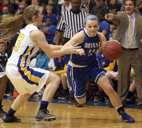 Bryant's Logan Davis tries to drive around Sheridan's Ashton Hill. (Photo by Rick Nation)