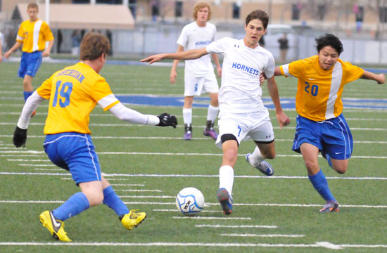 Bryant's Josh Lowery splits a pair of Sheridan defenders. (Photo by Kevin Nagle)