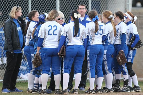 Bryant Lady Hornets coach Debbie Clark huddles with her team between innings. (Photo by Rick Nation)