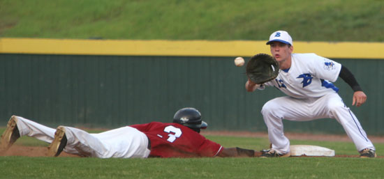 Ty Harris takes a pick-off throw as Pine Bluff's Aaron McDonald (3) dives back in to first. (Photo by Rick Nation)