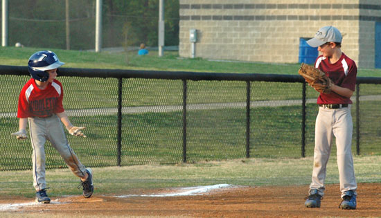 Middleton base-runner Clay Crawford visits with his friend, ASP third baseman C.J. Nagle, during Tuesday's game at Bishop Park. (Photo courtesy of Val Nagle)