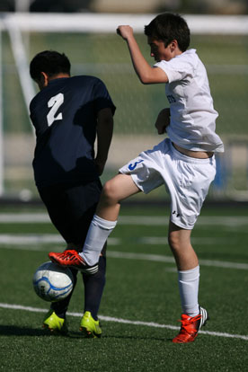 Dylan Wolf, right, controls the ball as a Fair player tries to avoid a collision. (Photo by Rick Nation)