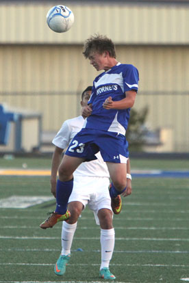 Cory Ballew heads the ball in front of a Sheridan player. (Photo by Rick Nation)