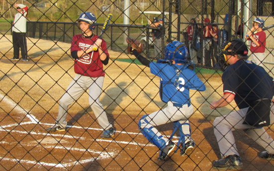 Jacob Coppock takes a high and tight pitch as Lee James Agency catcher Hunter Ulmer hauls it down during Monday's action. (Photo courtesy of Lara James)