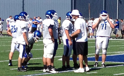 Head football coach Paul Calley talks with his offensive line during Wednesday's practice.