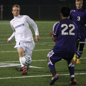 Austin Powell (1) tries to drive past an El Dorado defender. (Photo by Rick Nation)