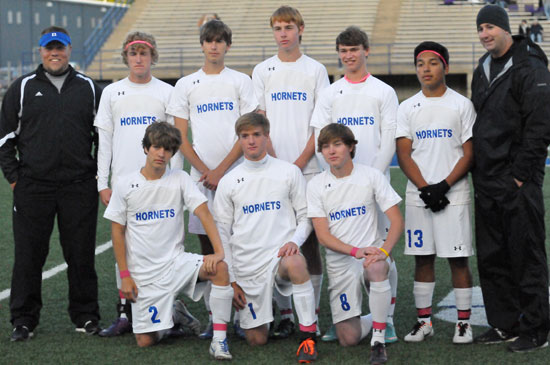 Bryant coaches Brett Haugh, left, and Jason Hay with the 2013 senior Hornets soccer players, front from left, Dylan Rives, Austin Powell, Chase Stuart; back row, Cameron Furton, Josh Lowery, Jeremy Anderson, Justin Travis, and Francisco Zamora. (PHoto by Kevin Nagle)