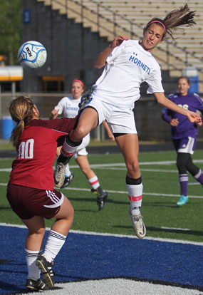 Bryant's Shelby Gartrell leaps to get a shot past the El Dorado keeper. (Photo by Rick Nation)