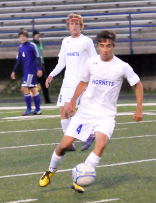 Dylan Wolf (4) moves upfield in front of Cameron Furton. (Photo by Kevin Nagle)